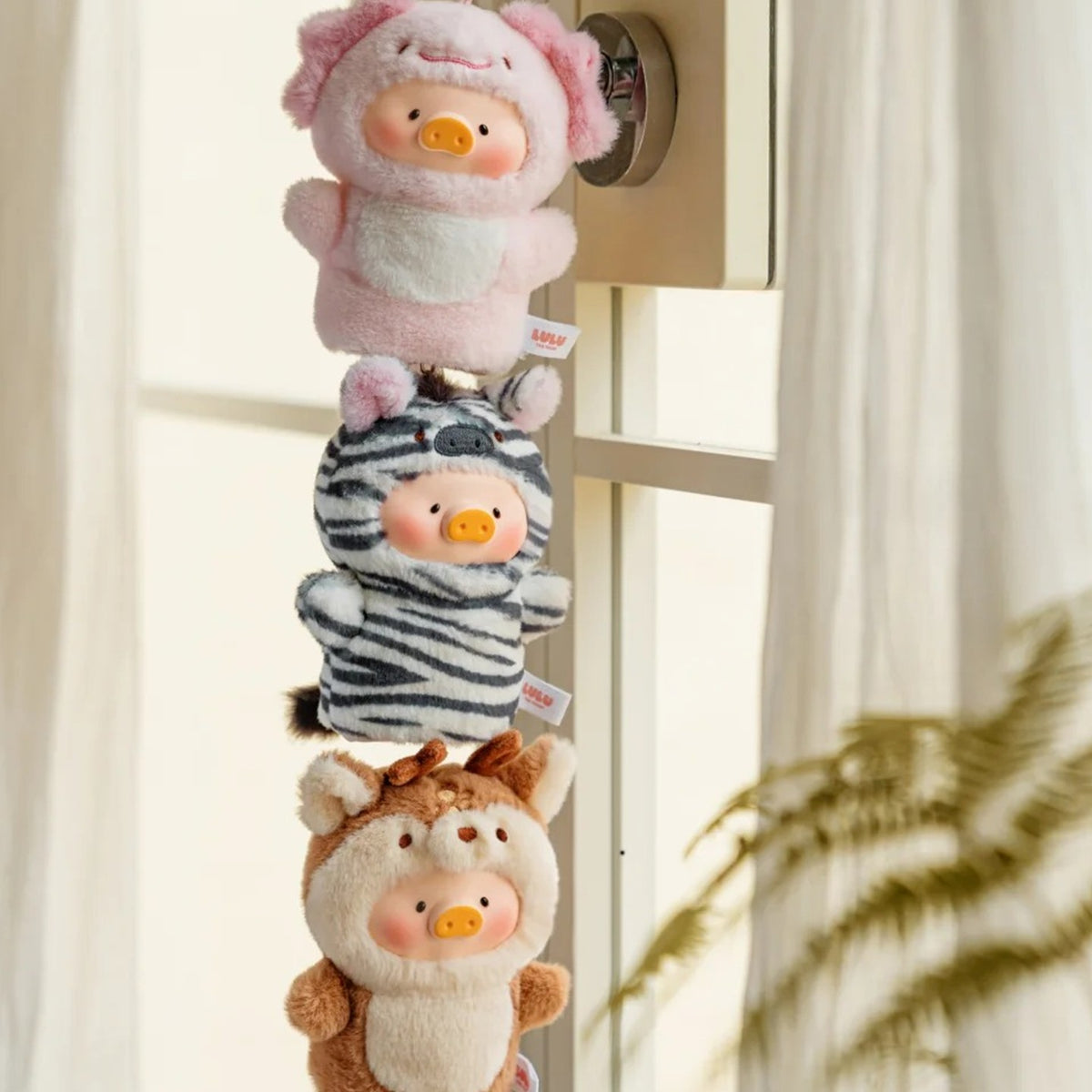 LuLu Cutest Butler key covers shown hanging in a display setting