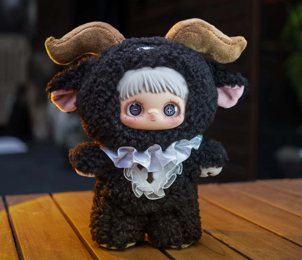 MAYMEI Axel Black plush doll in a black horned costume with white ruffle, complete front view