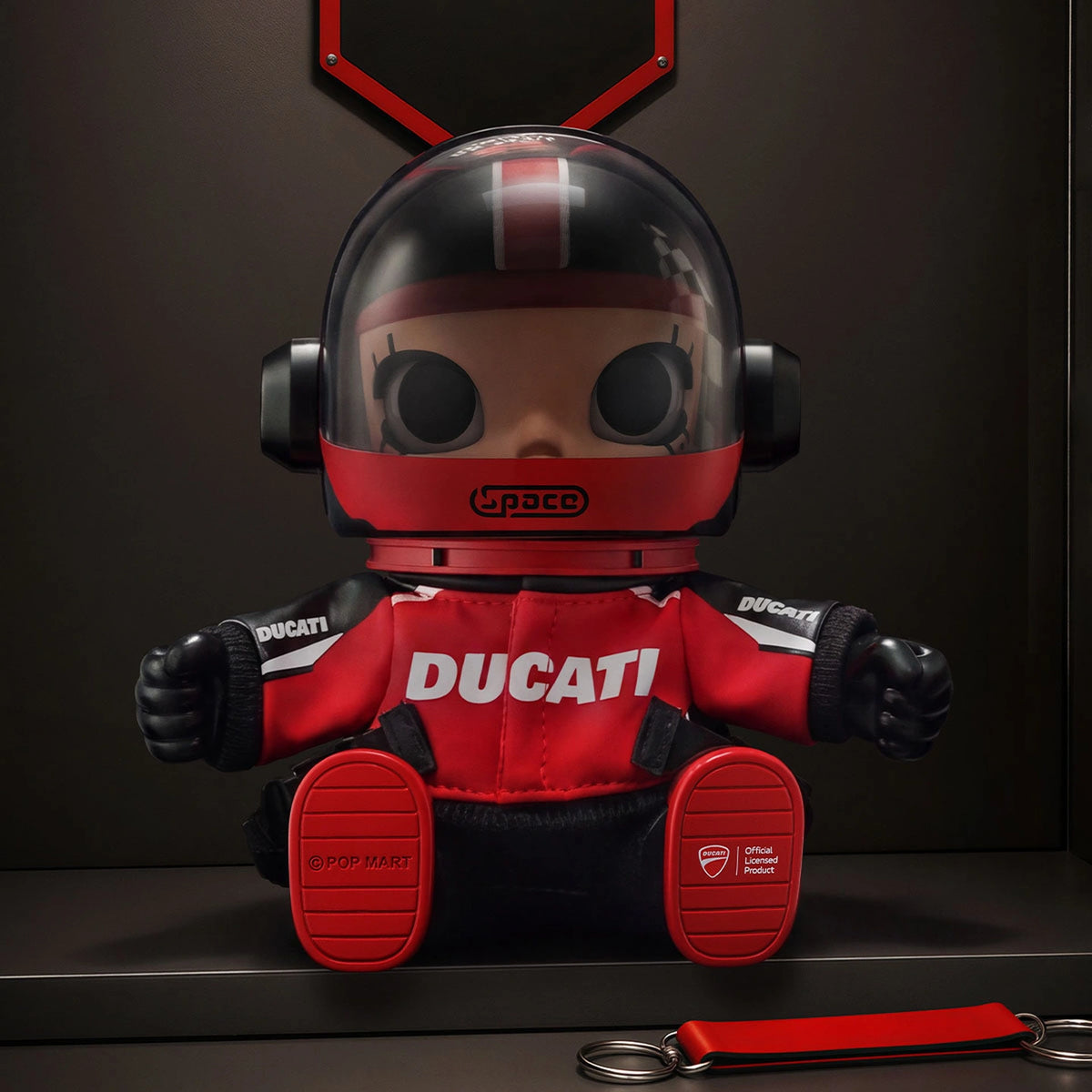 MEGA SPACE MOLLY DUCATI red vinyl plush pendant with helmet visor closed; original studio display scene