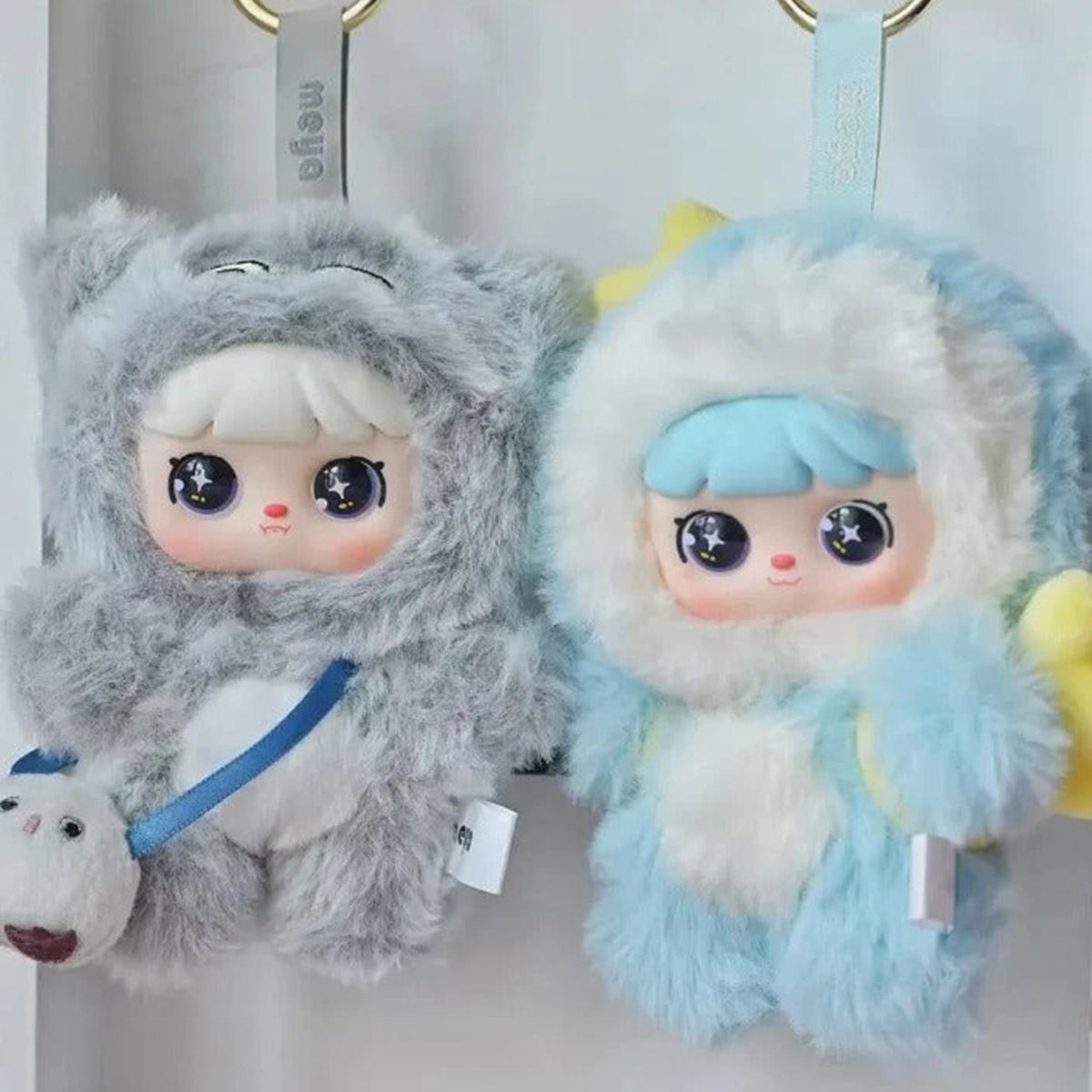 MEYA V2 Cute Pet Action Series Plush Dolls, Blind Box - Grey and blue plush pendant bodies with visible hanger straps; random design not guaranteed