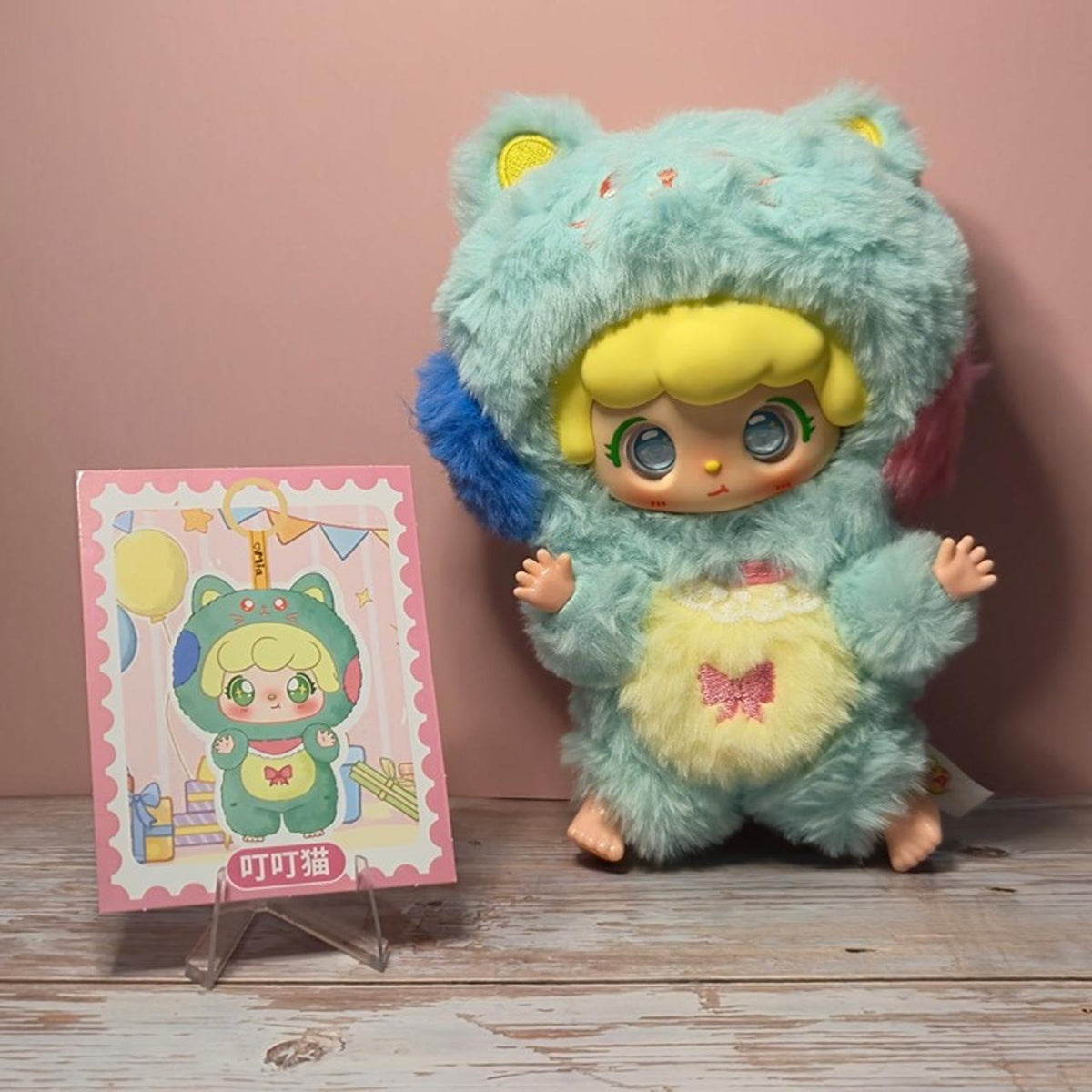 MIA Meng Youji green cat-hood plush — physical series example with reference card, not guaranteed blind-box contents