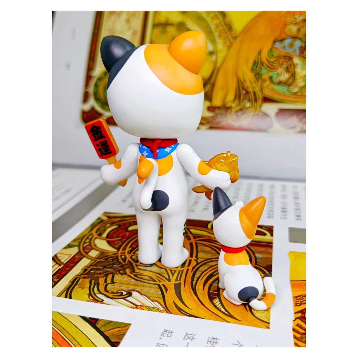 MOLLY Lucky Cat confirmed figurine, rear view showing the costume and tail