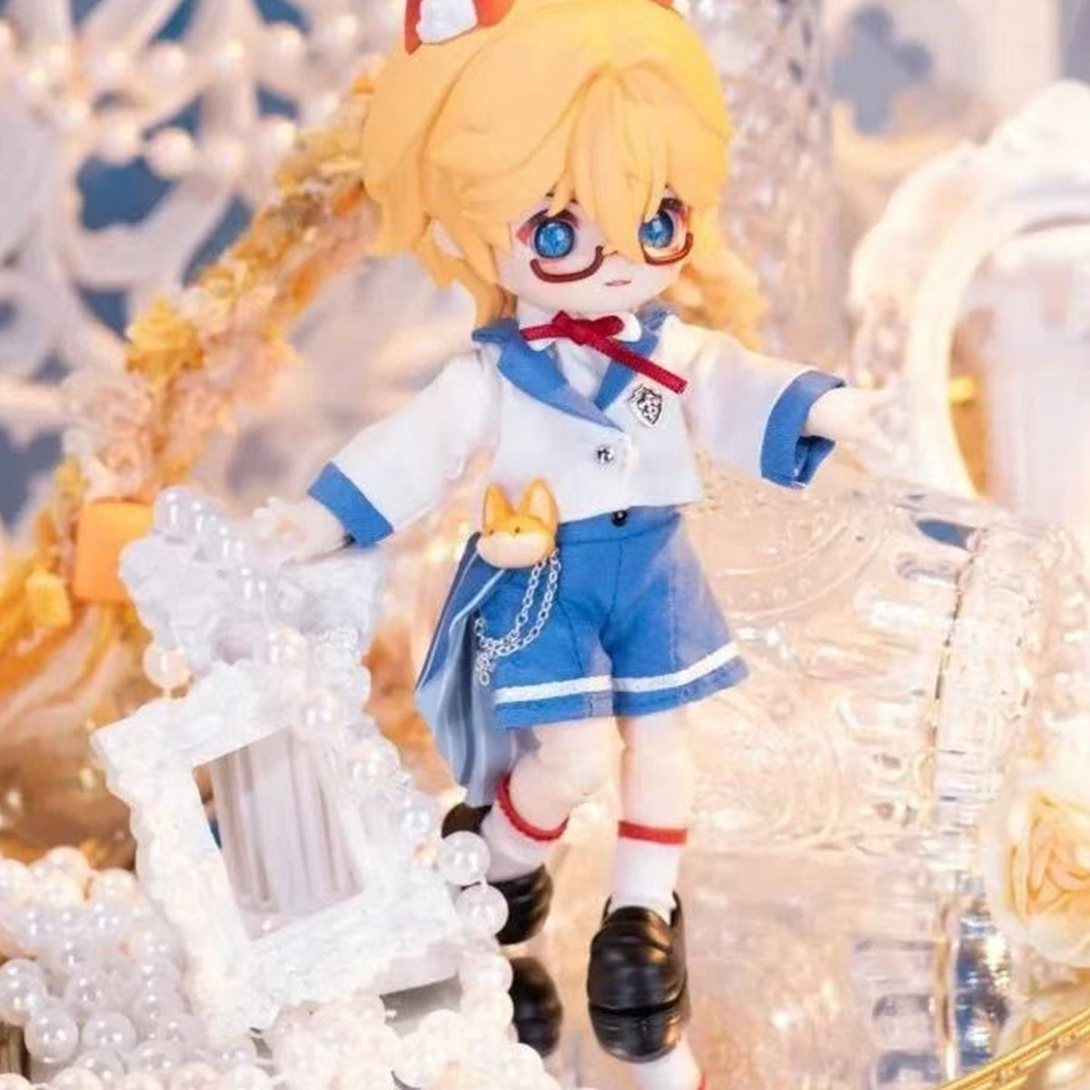 NAGI Illusory Realm blond doll with glasses, blue shorts and white-and-blue outfit details; series example