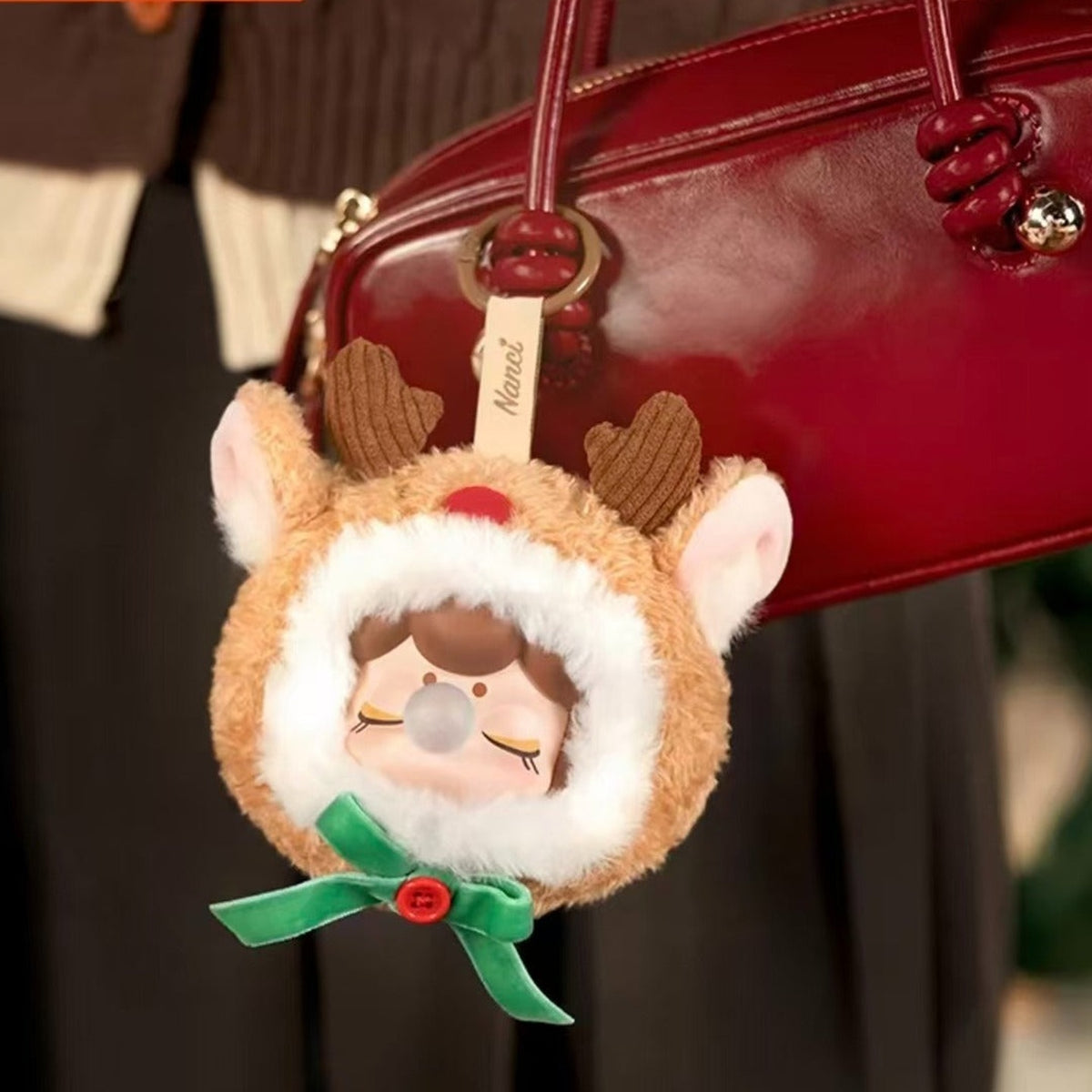Nanci Christmas Gift: Christmas Gift reindeer pendant attached to a bag; bag is a display prop