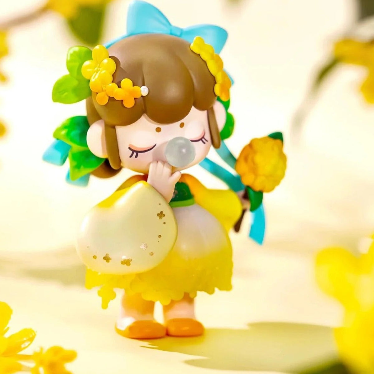 Nanci Flower Stories: Brown-haired Nanci figure with yellow blossom details