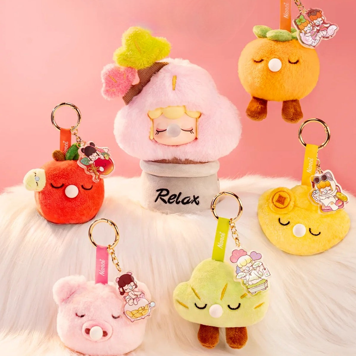 Nanci Good Luck Comes Around: Good Luck Comes Around plush pendants displayed with a separate pink display plush; display props are not included