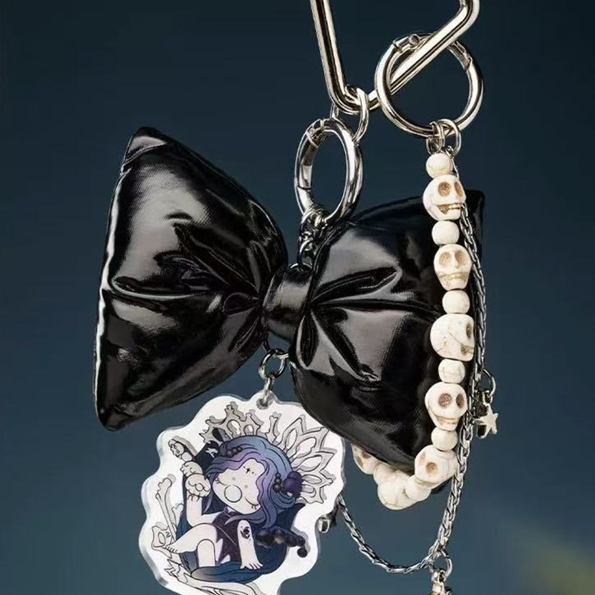 Nanci Secret Fantasy Plush Pendants: Bone Queen Secret Fantasy pendant with a black bow and printed character charm