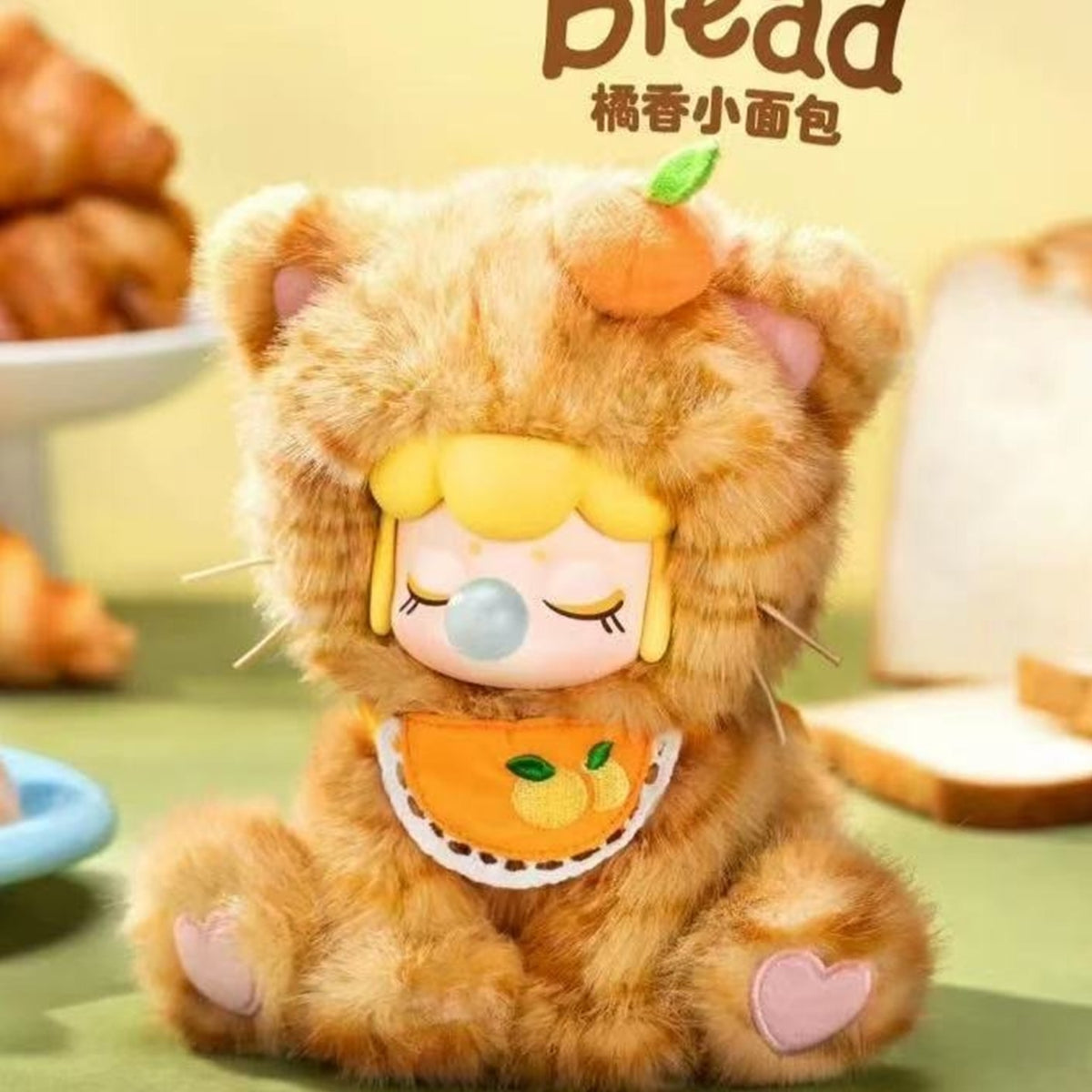 Nanci Tea Time Kitties: Golden kitten plush design wearing an orange bib