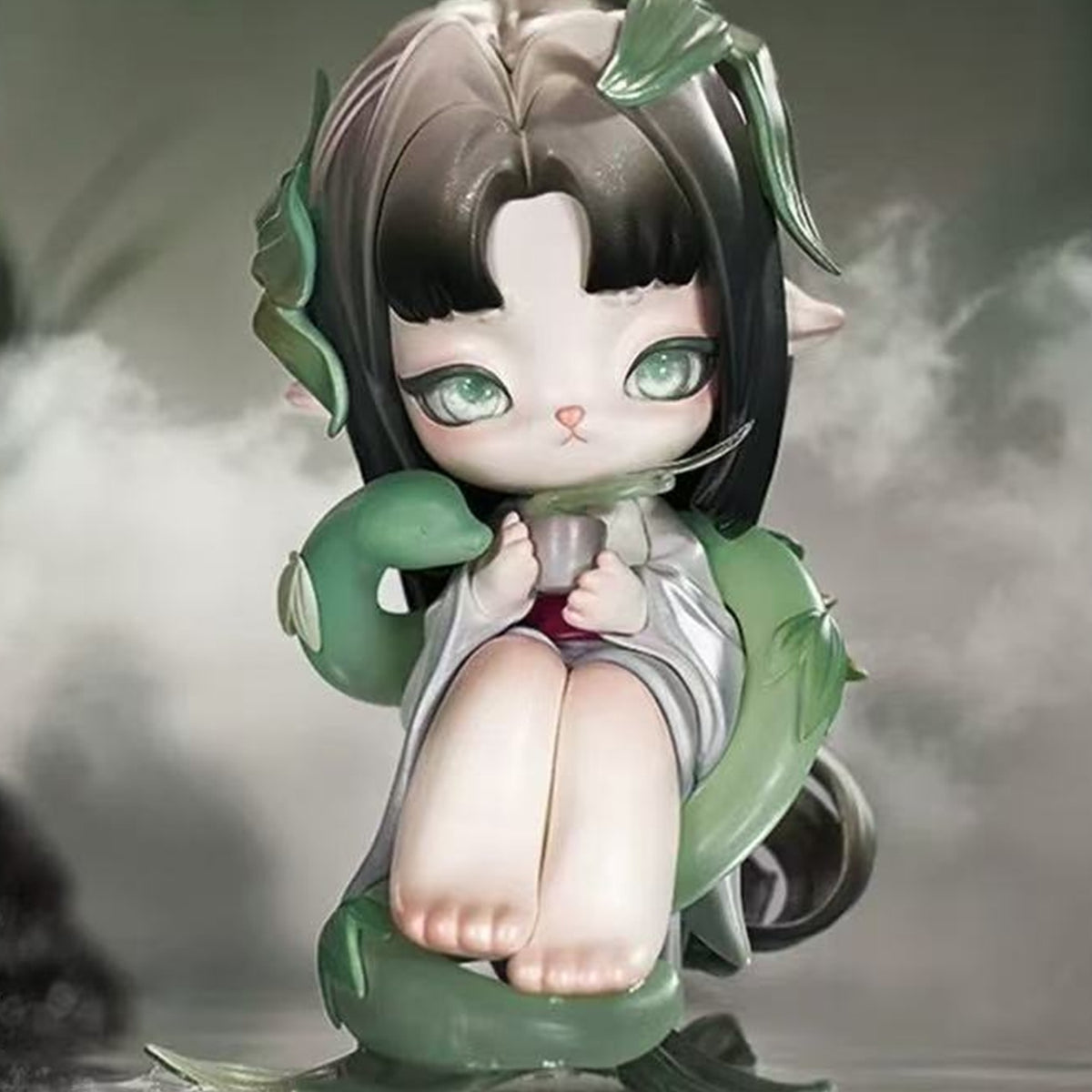 Ninimo Whispering Seasons Series Figure Blind Box - Dark-haired seated figure in green bamboo-inspired outfit; upper leaf ornament cropped; random design not guaranteed; display props not included