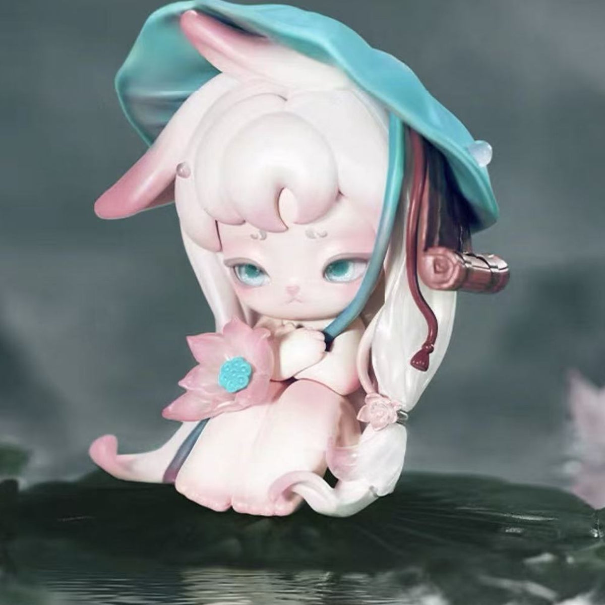 Ninimo Whispering Seasons Series Figure Blind Box - White-haired seated figure with teal lotus-shaped headwear; upper headwear cropped; random design not guaranteed; display props not included