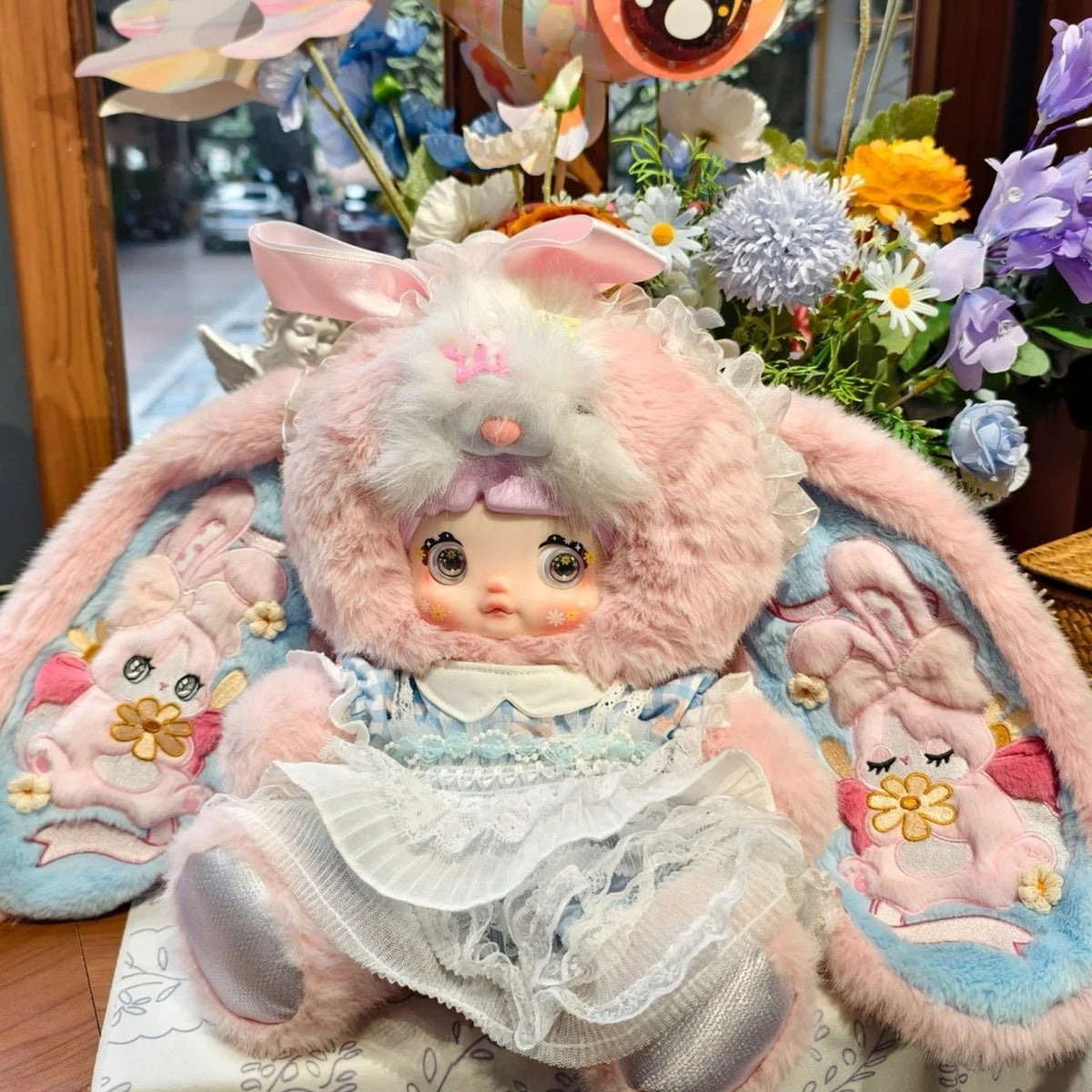 Nommi Little Daisy 400% Series Limited Plush Doll - Little Daisy plush doll seated detail with lower feet and outer ears at edge; single doll; props not included