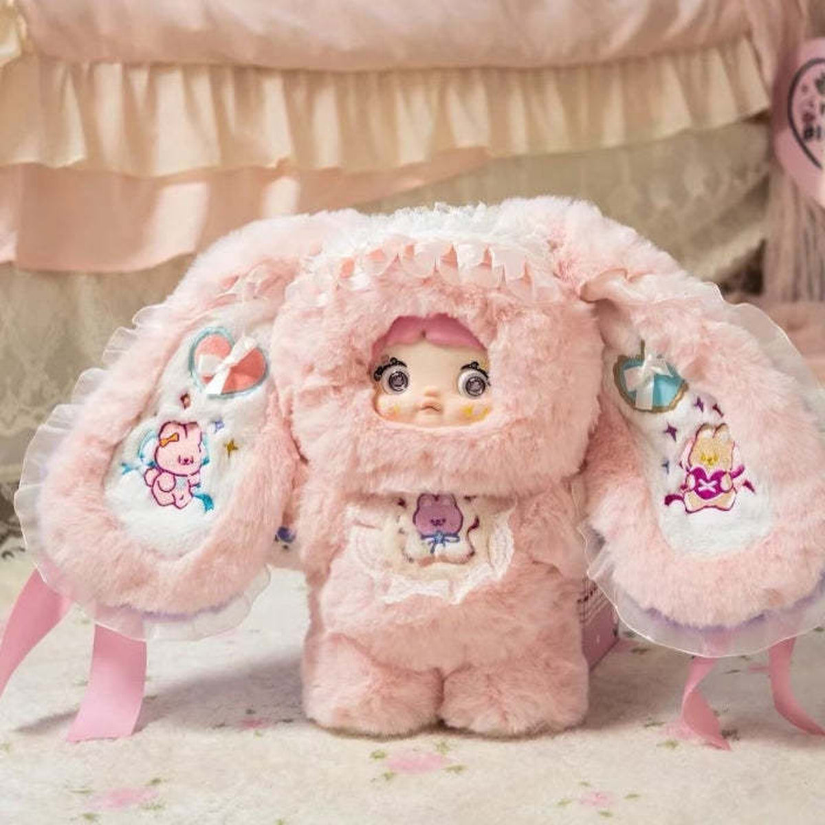 Nommi Sweet Tea Bunny 400% Plush Doll, Limited Edition - Complete pink bunny plush doll front view on seat; one Sweet Tea Bunny doll; props not included