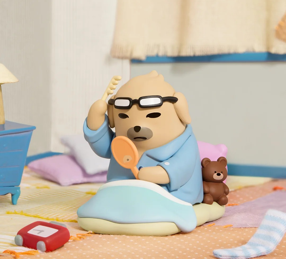 NUDAENG Just Dog It blind-box figure series: dog figure in sleepwear on a bed, shown as a possible design