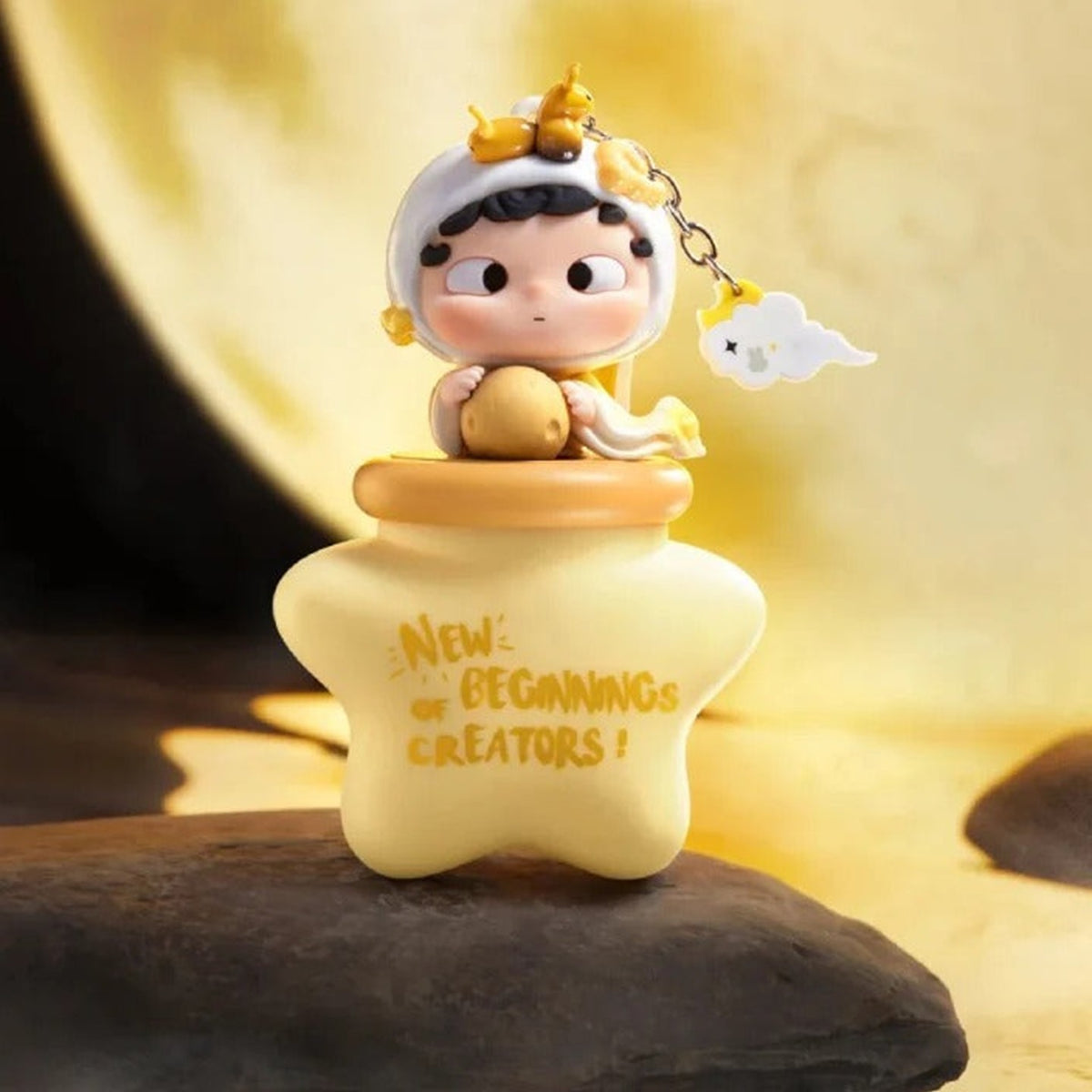Ozai New Beginnings Of Creators-Glow-In-The-Dark Pendant Blind Box - Complete yellow figure keychain example with star body; upper attachment cropped; display props not included; random design not guaranteed