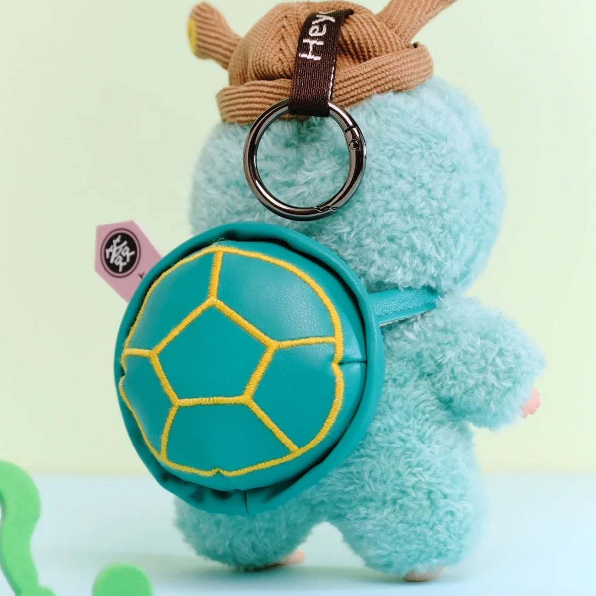 Ozai YAO GUAI Kindergarten Series Plush Dolls, Blind Box - Rear view of turquoise plush with shell-shaped accessory and hanging ring; upper hat cropped; random design not guaranteed; display props not included