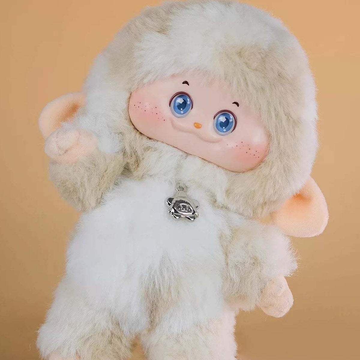 PIMOMO Vinyl Face Series Plush Dolls, Blind Box - Cream-colored PIMOMO vinyl-face plush detail with raised hand and chest charm; lower feet cropped; random design not guaranteed; display props not included