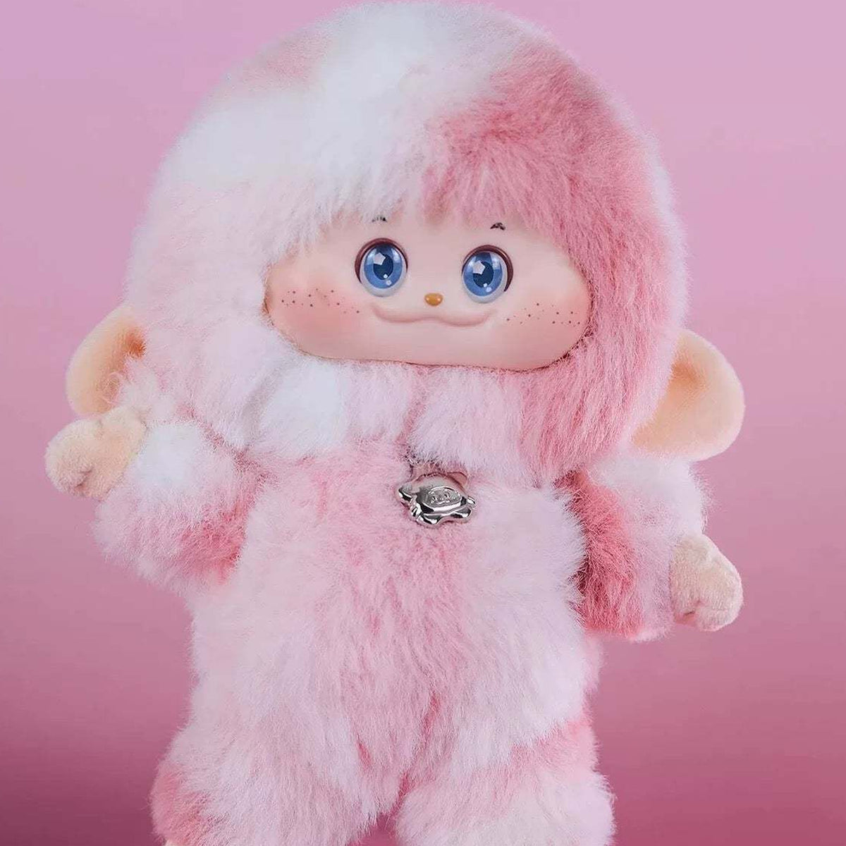 PIMOMO Vinyl Face Series Plush Dolls, Blind Box - Pink-and-white PIMOMO vinyl-face plush detail with raised hand and chest charm; lower feet cropped; random design not guaranteed; display props not included