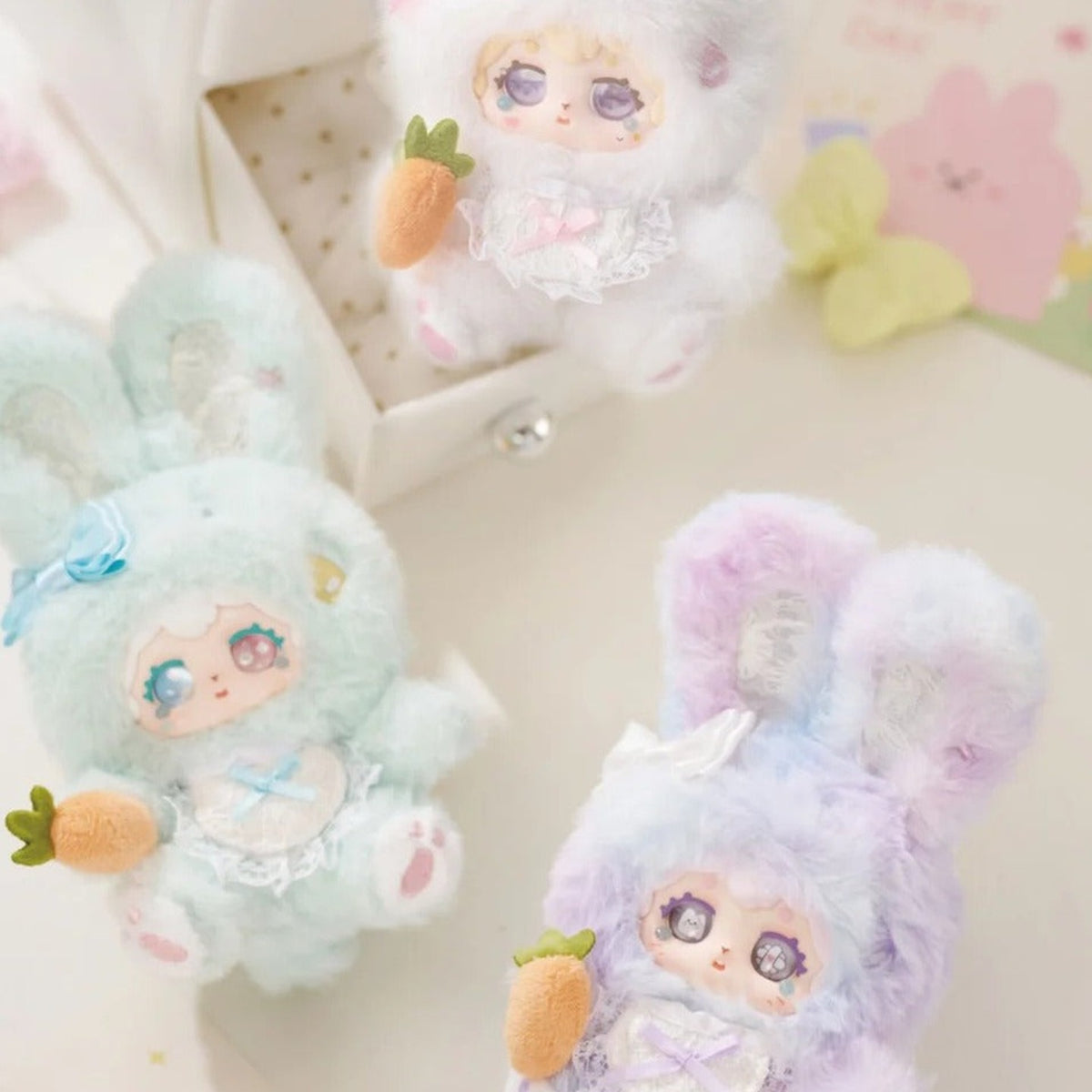 POKA Fluffy Collection: Three pastel rabbit-suit POKA plush designs in a natural scene; group is illustrative