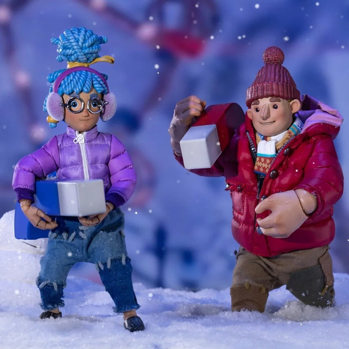 It Takes Two Winter Series May and Cody standing in the snow with blue and red magnet props
