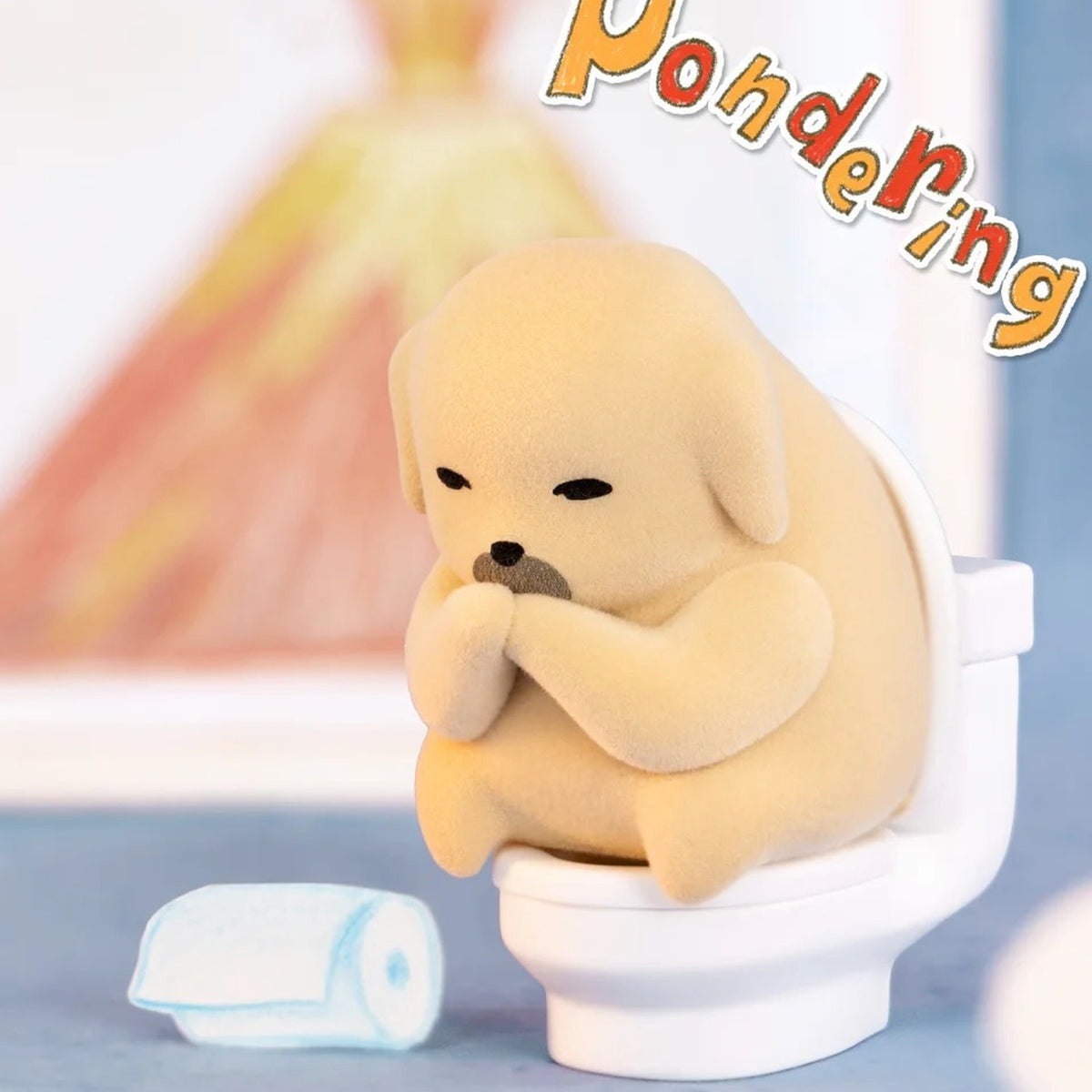 NUDAENG The Meh Pondering design seated on a miniature toilet with hands together
