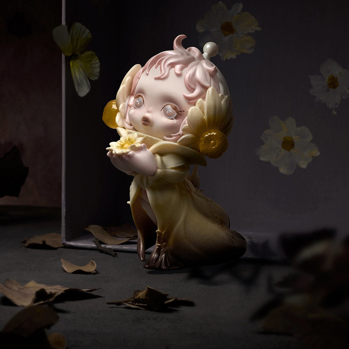 SKULLPANDA Petals in Four Acts pale figure with yellow floral details, kneeling while holding a small flower; random design is not guaranteed.