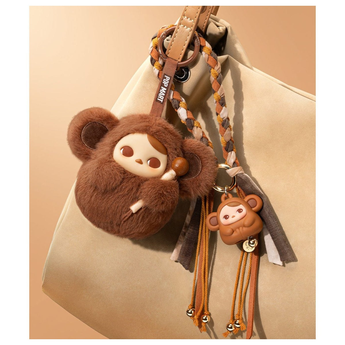 PUCKY Tap Tap Babies pendant blind box series - brown pendant design example displayed on a bag with a separate bear plush; bag and plush not included