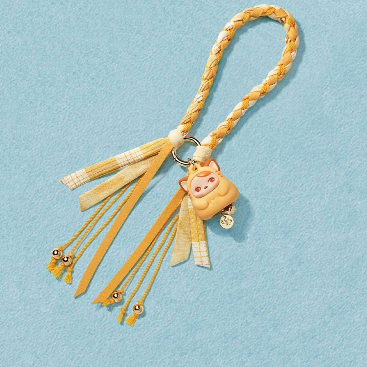 PUCKY Tap Tap Babies pendant blind box series - yellow pendant design example on a blue display background