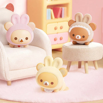 Rilakkuma Minna de Usausababy Series Figure Blind Box - Three complete baby-costume figure examples in a styled room; random design not guaranteed
