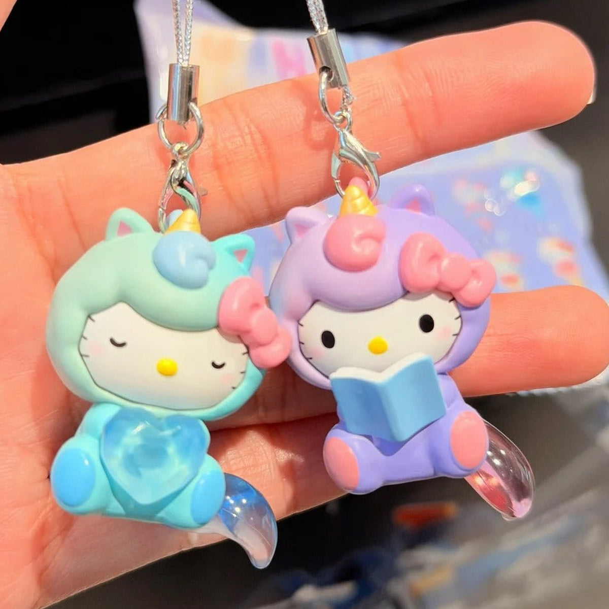 SANRl0 HK Dreamy Adventure Series Mini Figure Blind Box - Complete green and purple mini figure pendant bodies with straps extending beyond upper edge; pictured design not guaranteed
