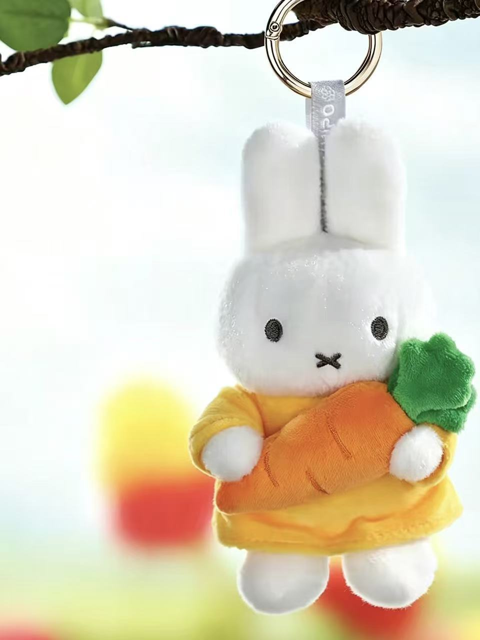 Miffy Hug carrot plush pendant hanging from its metal ring