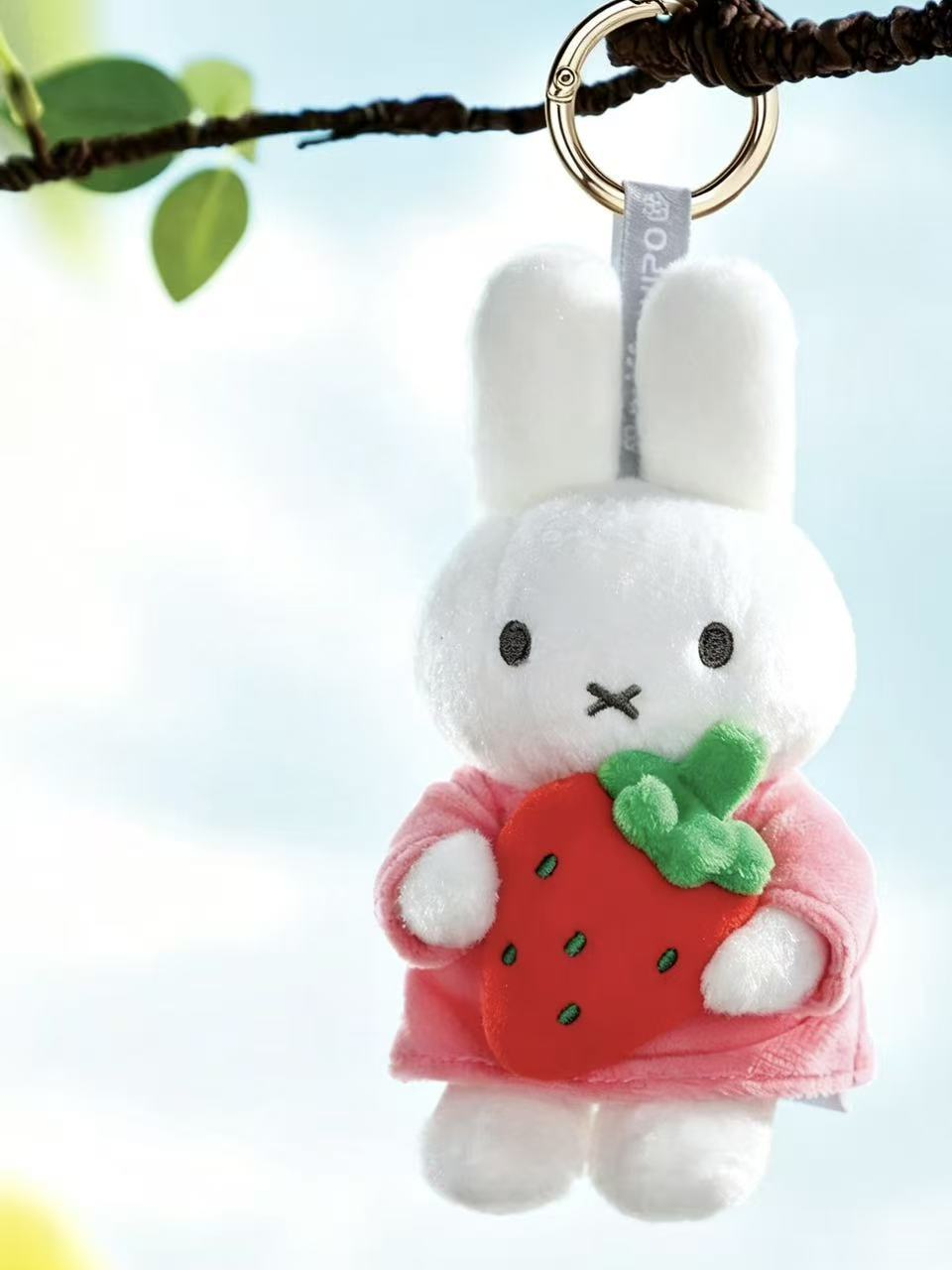 Miffy Hug strawberry plush pendant hanging from its metal ring